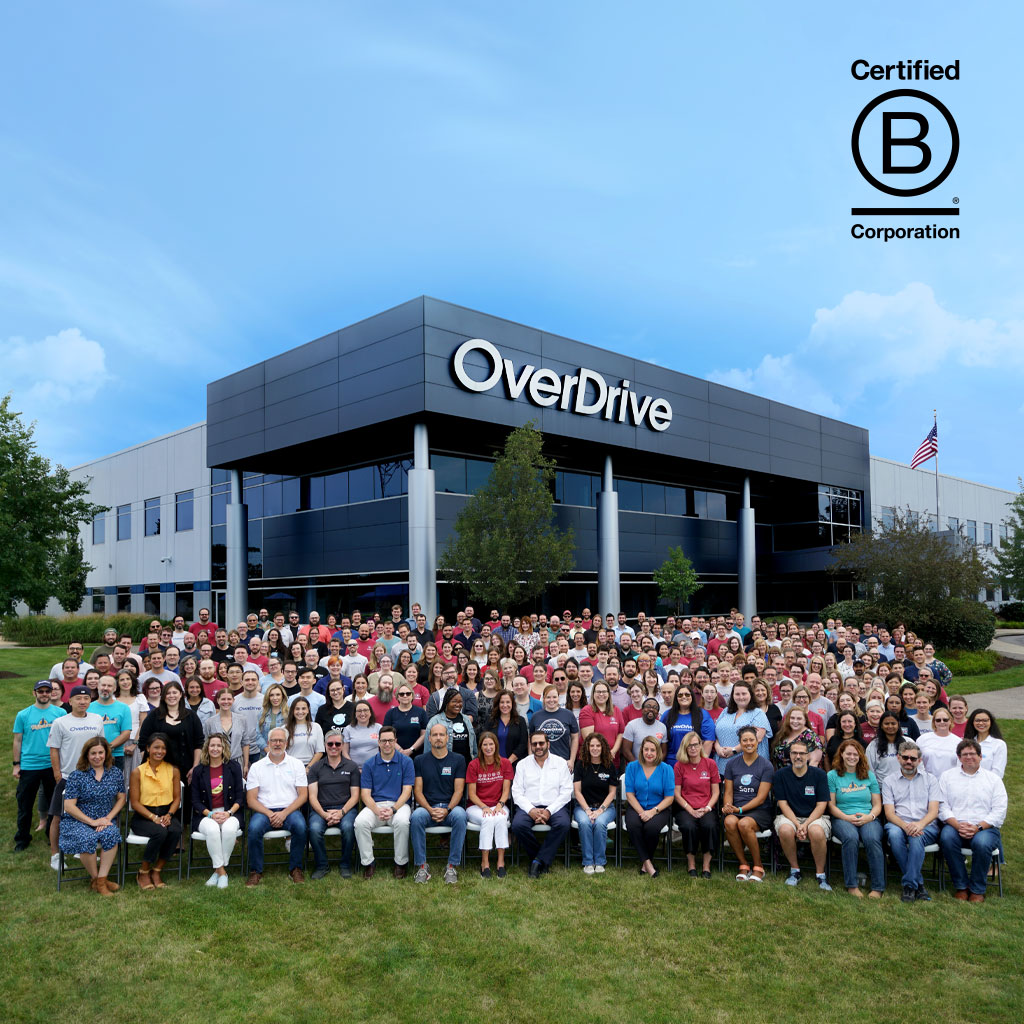 Company photo of employees sitting outside of the OverDrive building