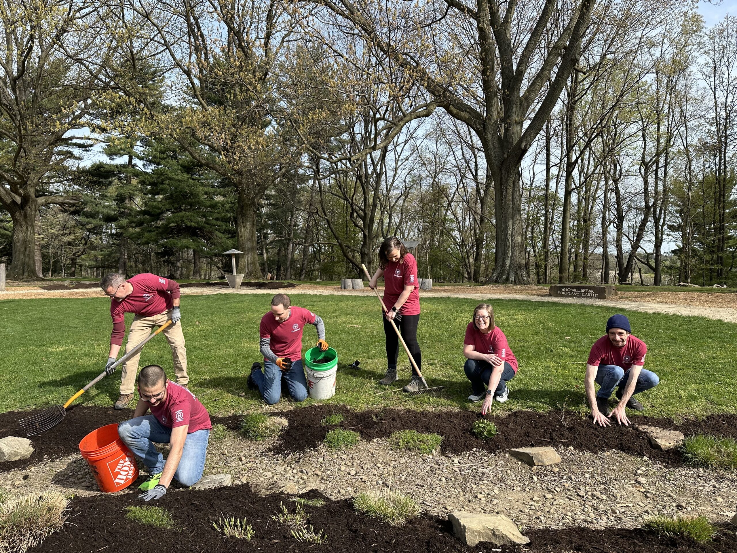 Employees putting down mulch at a volunteer event