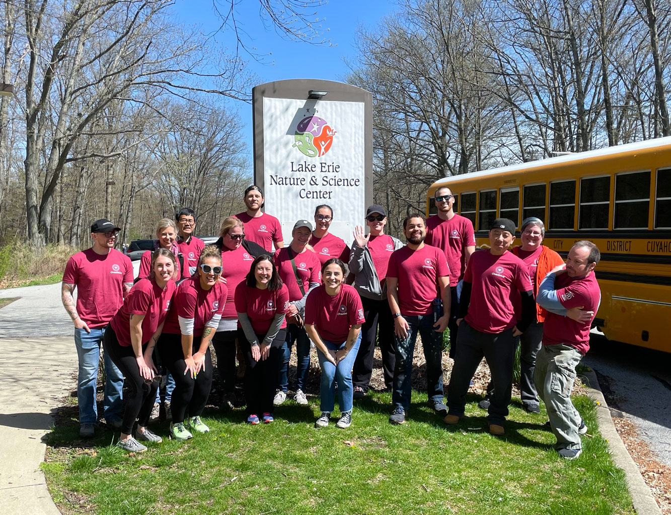 Employees posing in front of the Lake Erie Nature & Science Center sign
