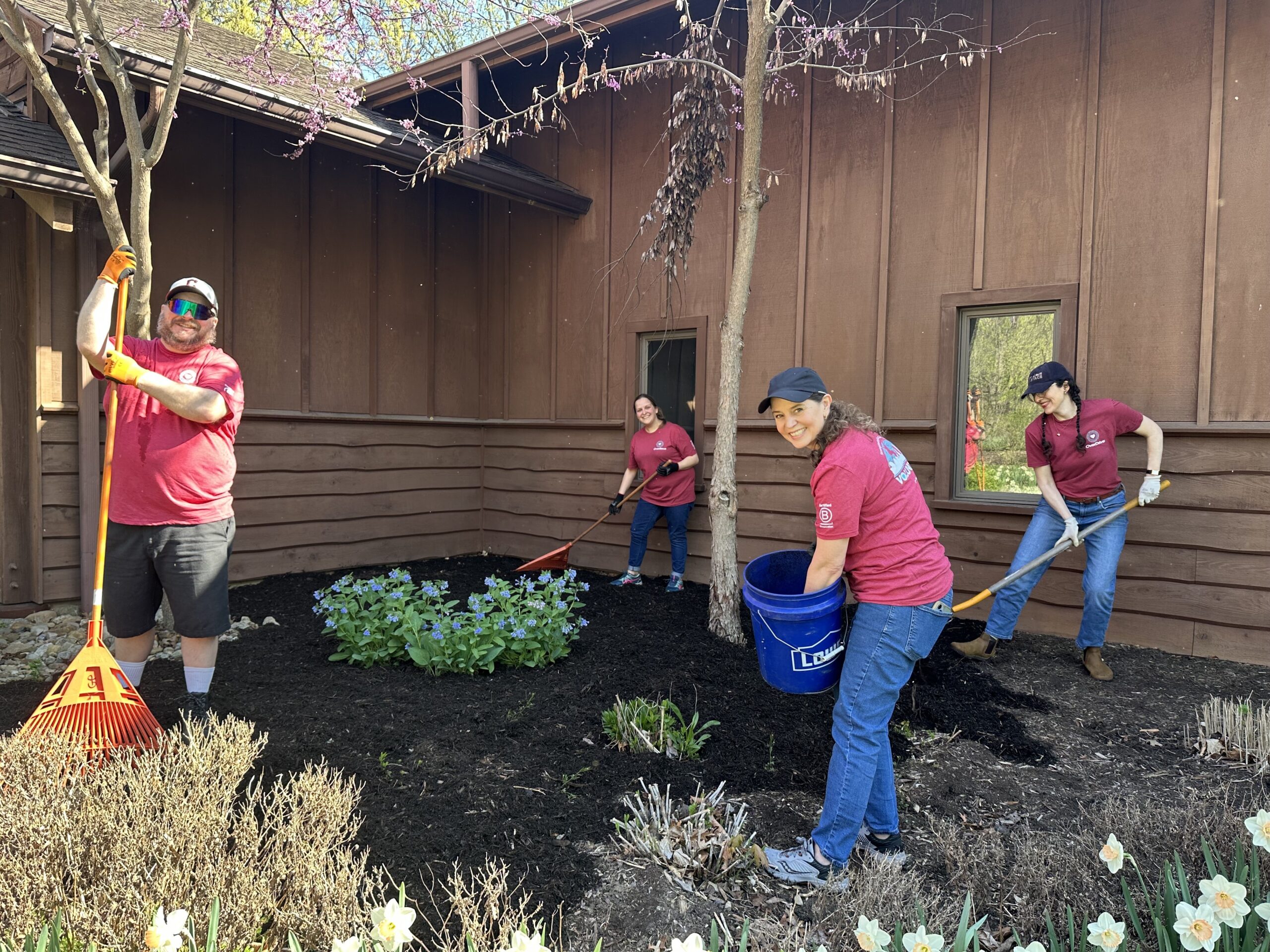 Employees putting down mulch at a volunteer event