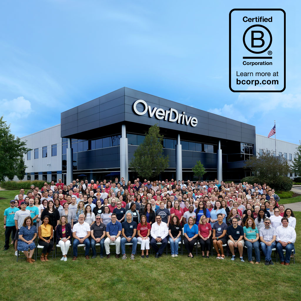 Company photo of employees sitting outside of the OverDrive building